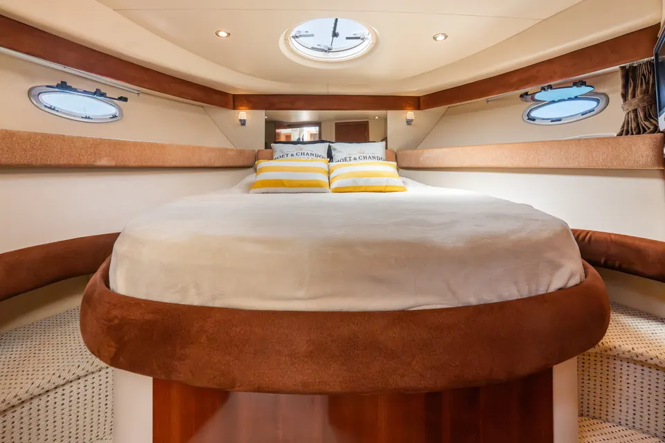 A double berth in the bow, lit by overhead portholes.