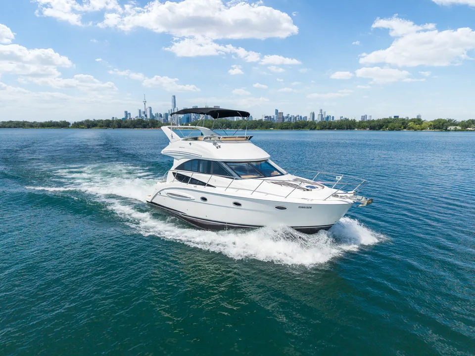 The 36&prime; Double Decker Yacht under way past the Toronto skyline.
